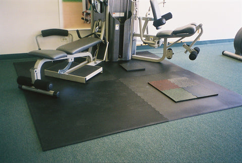 Home gym workout kit with rubber tile floor and exercise equipment.